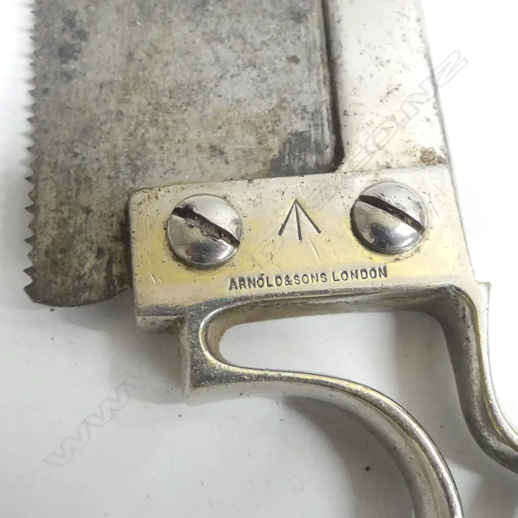An old surgical saw for amputations marked with a military arrow to metal handle Image 1++