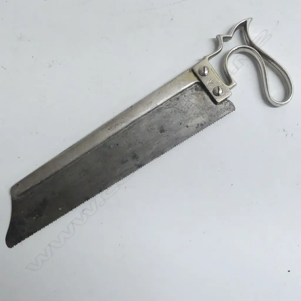 An old surgical saw for amputations marked with a military arrow to metal handle Image 1++