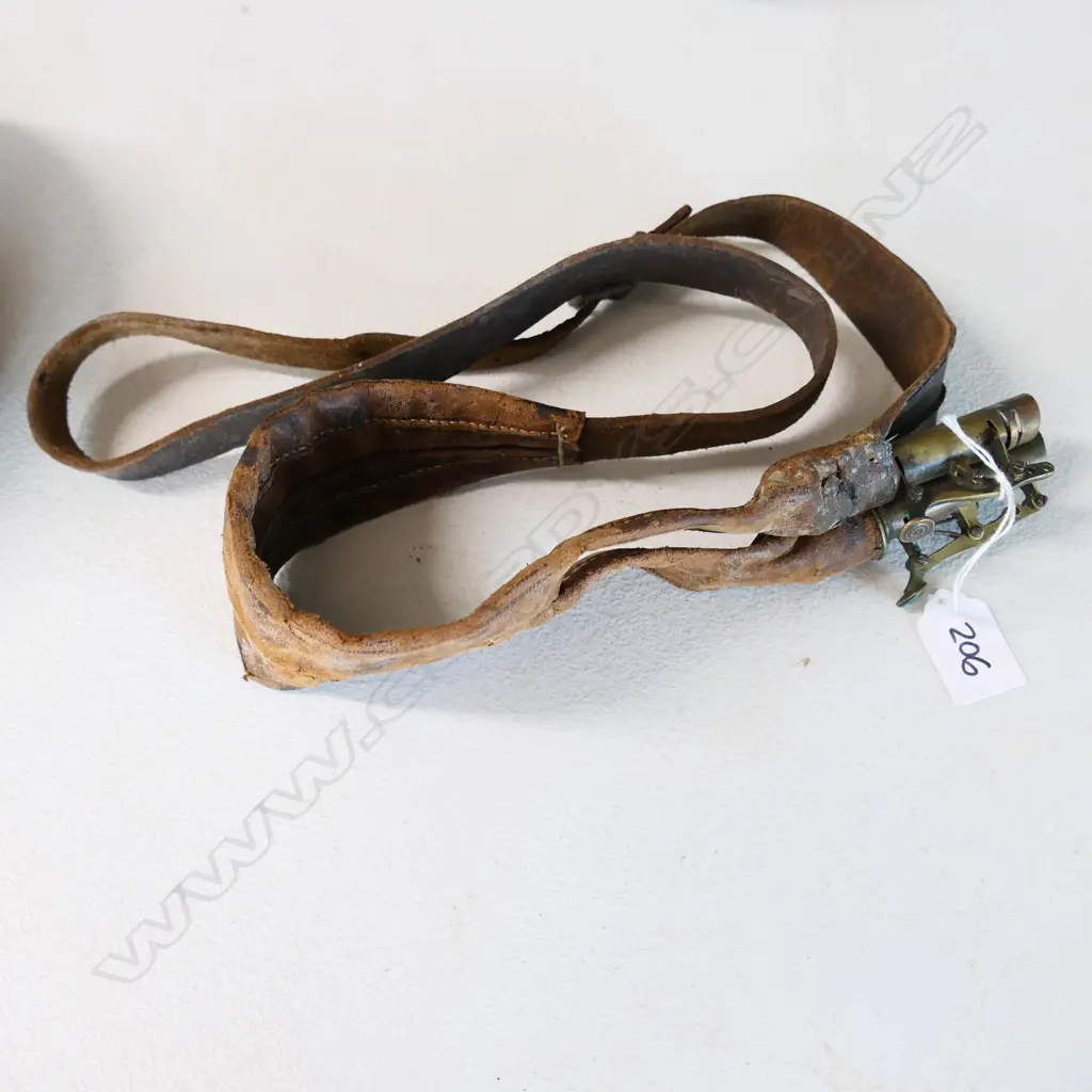 An over-the-shoulder leather double compartment shot pouch, with two brass lever action controlled nozzles. Image 1++
