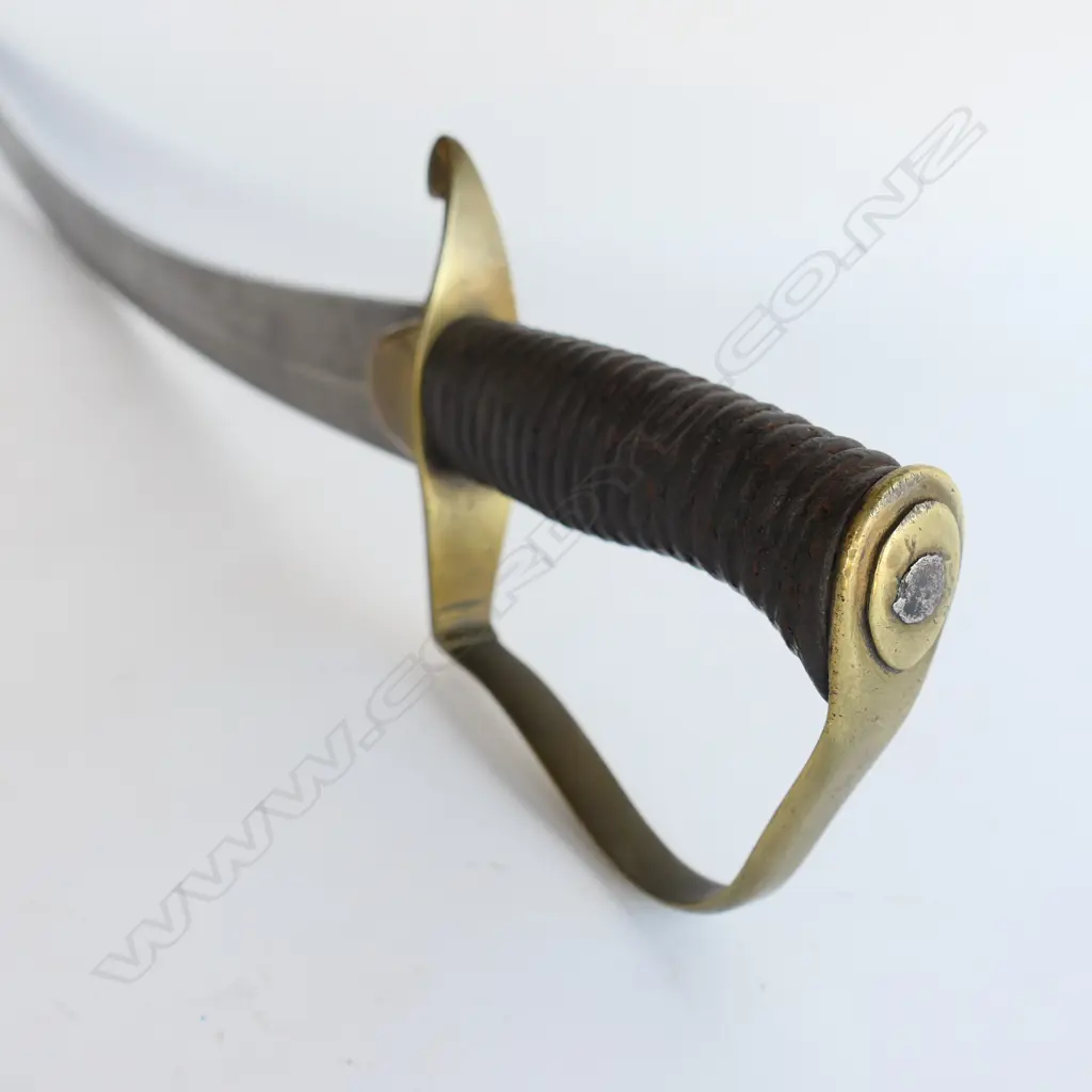 A Light Cavalry Officer’s Pattern 1796 Sabre, marked ‘Osborn’ on blade back, with brass stirrup hilt with half-round langets, iron grooved grip, single fullered 755mm blade. No scabbard Image 1++