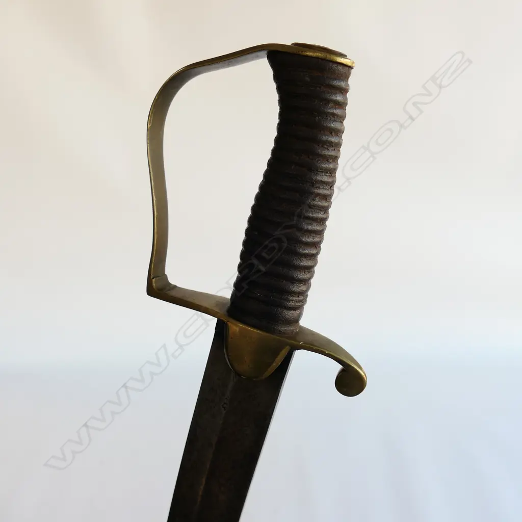 A Light Cavalry Officer’s Pattern 1796 Sabre, marked ‘Osborn’ on blade back, with brass stirrup hilt with half-round langets, iron grooved grip, single fullered 755mm blade. No scabbard Image 1++