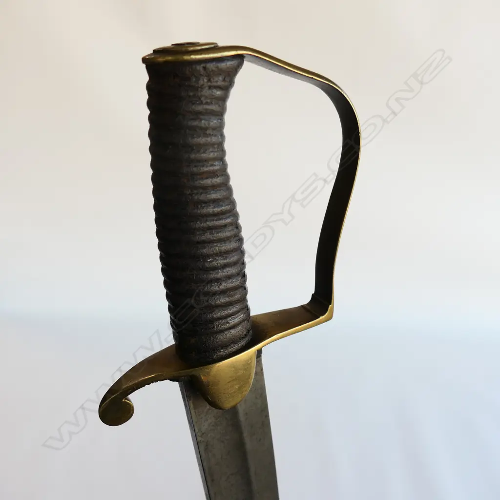 A Light Cavalry Officer’s Pattern 1796 Sabre, marked ‘Osborn’ on blade back, with brass stirrup hilt with half-round langets, iron grooved grip, single fullered 755mm blade. No scabbard Image 1++