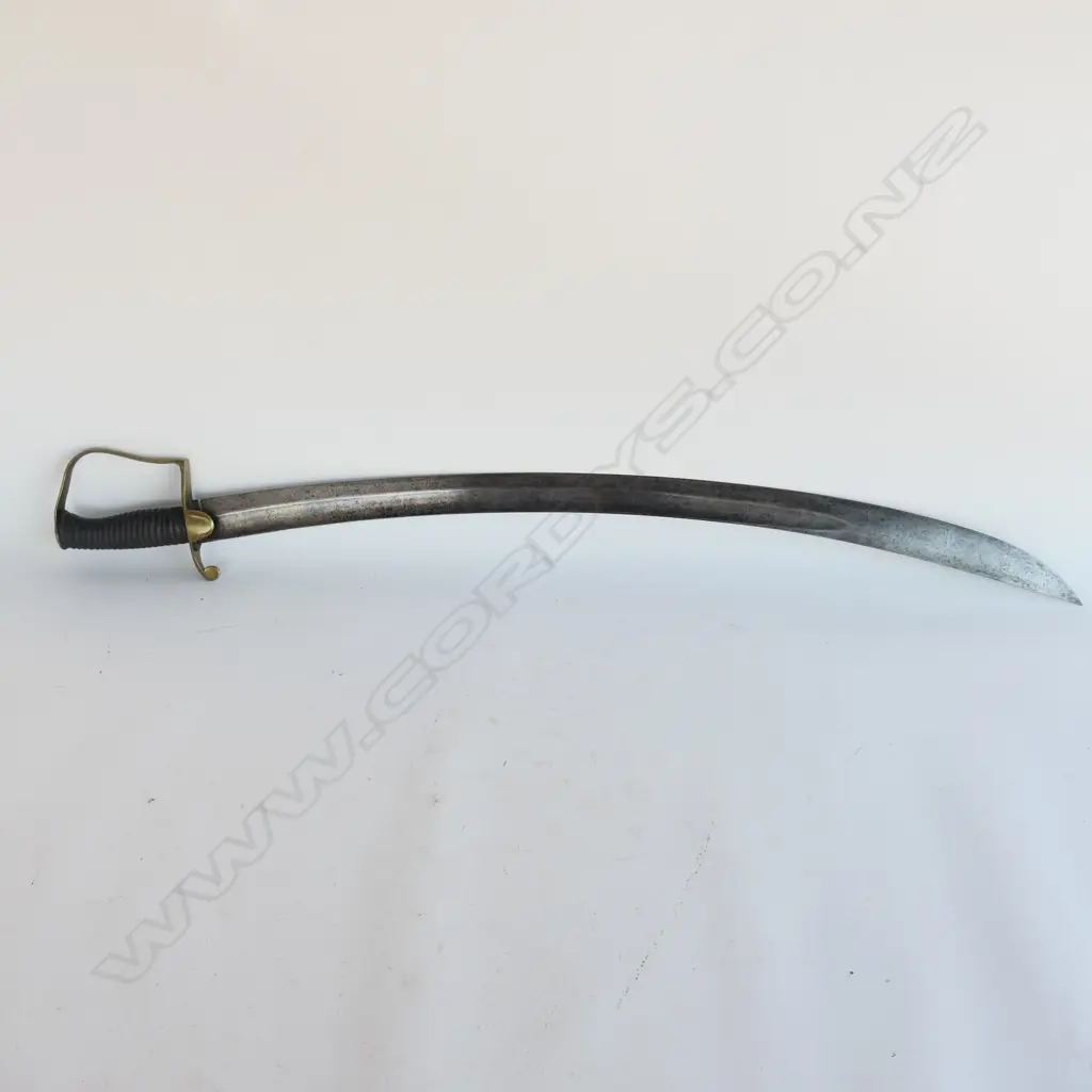 A Light Cavalry Officer’s Pattern 1796 Sabre, marked ‘Osborn’ on blade back, with brass stirrup hilt with half-round langets, iron grooved grip, single fullered 755mm blade. No scabbard Image 1++