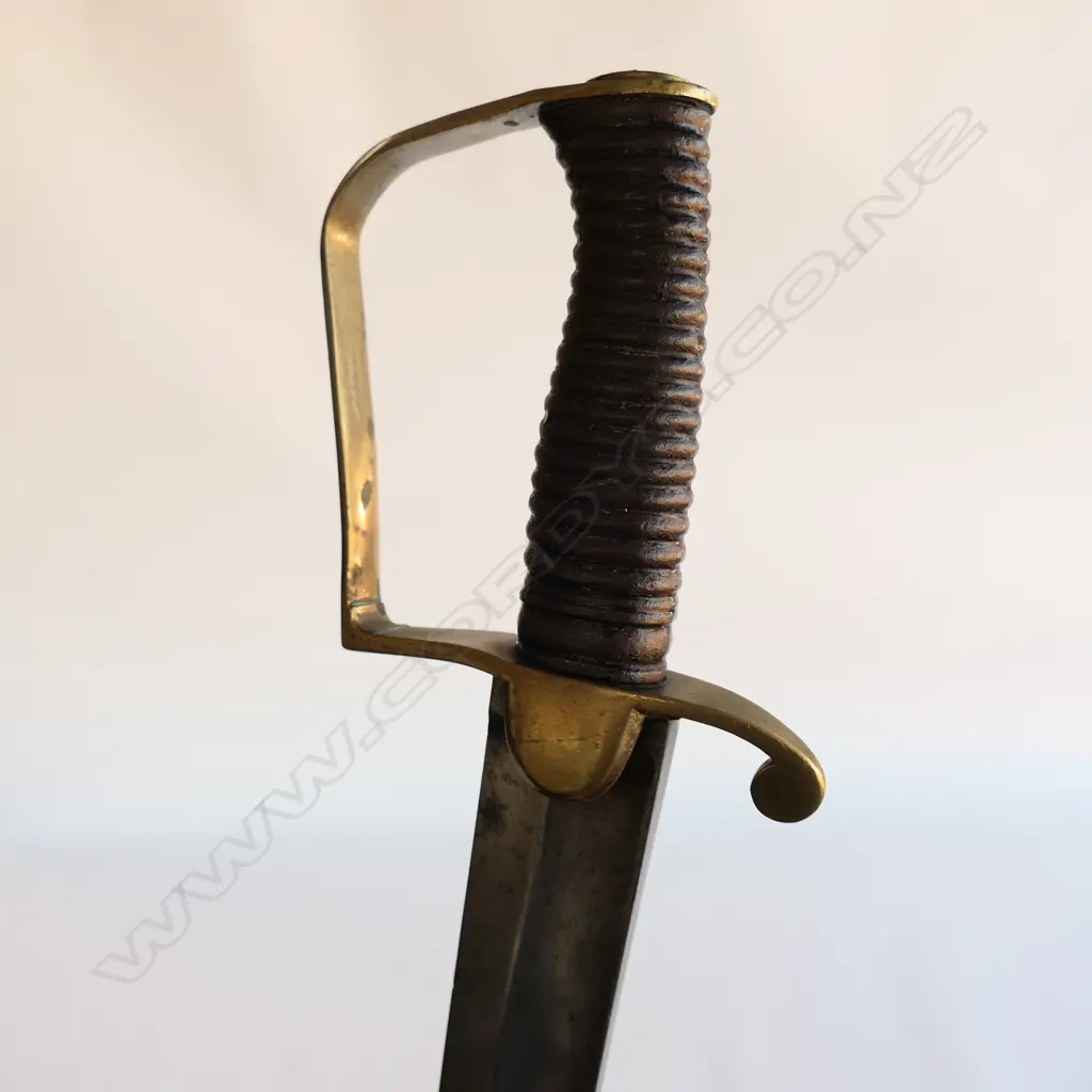A Light Cavalry Officer’s Pattern 1796 Sabre, marked ‘Osborn’ on blade back, with brass stirrup hilt with half-round langets, iron grooved grip, single fullered 755mm blade, cleaned, edge chips. No scabbard Image 1++