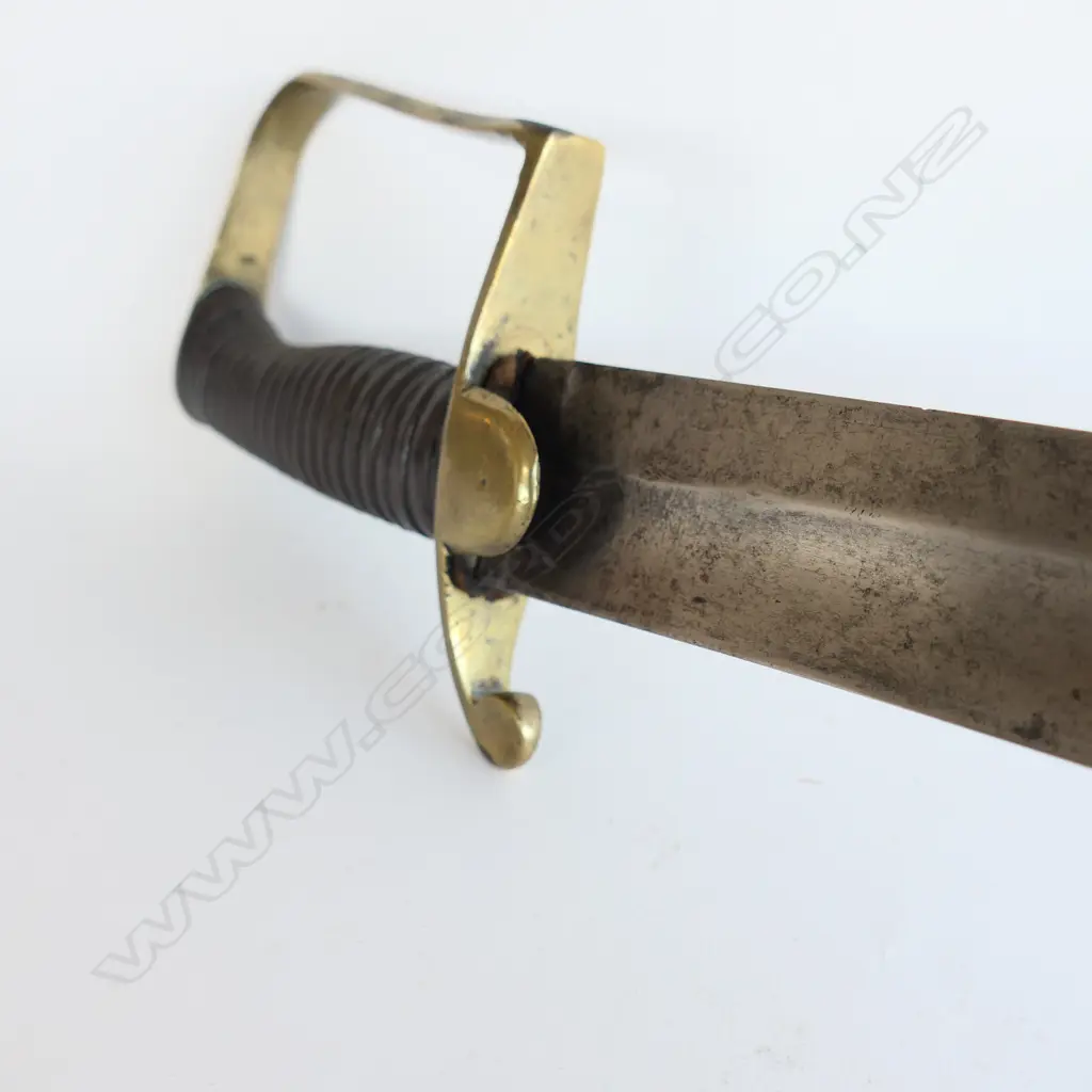 A Light Cavalry Officer’s Pattern 1796 Sabre, marked ‘Osborn’ on blade back, with brass stirrup hilt with half-round langets, iron grooved grip, single fullered 755mm blade, cleaned, edge chips. No scabbard Image 1++