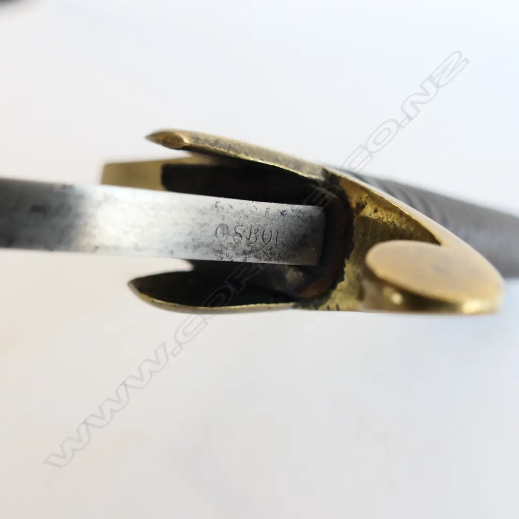 A Light Cavalry Officer’s Pattern 1796 Sabre, marked ‘Osborn’ on blade back, with brass stirrup hilt with half-round langets, iron grooved grip, single fullered 755mm blade, cleaned, edge chips. No scabbard Image 1++