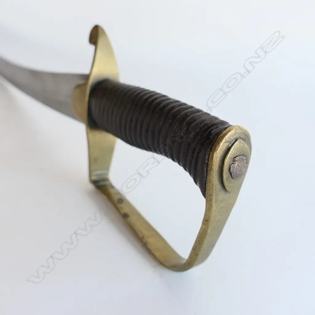 A Light Cavalry Officer’s Pattern 1796 Sabre, marked ‘Osborn’ on blade back, with brass stirrup hilt with half-round langets, iron grooved grip, single fullered 755mm blade, cleaned, edge chips. No scabbard Image 1++