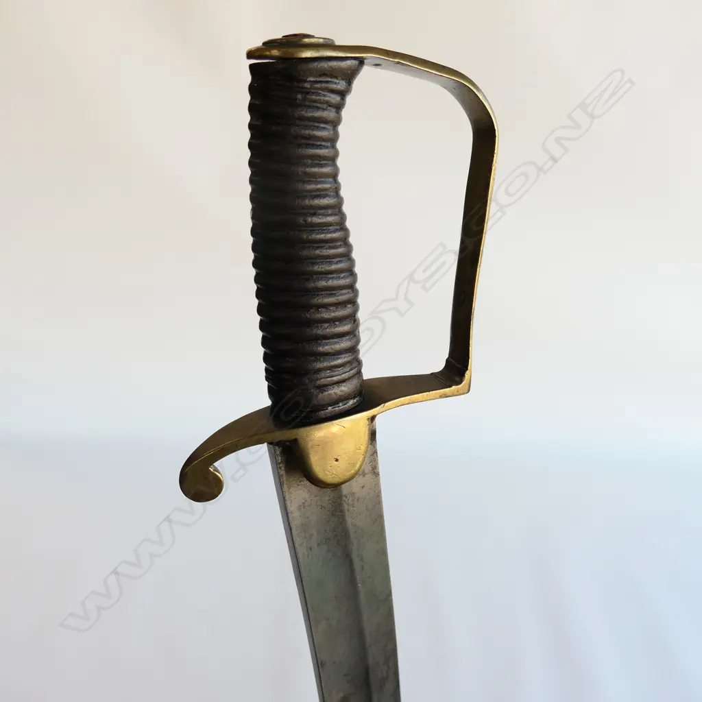 A Light Cavalry Officer’s Pattern 1796 Sabre, marked ‘Osborn’ on blade back, with brass stirrup hilt with half-round langets, iron grooved grip, single fullered 755mm blade, cleaned, edge chips. No scabbard Image 1++