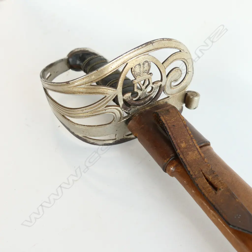 An 1845 pattern Officer's sword. As issued with very good brown leather scabbard. Nickel-plated hilt with open swept guard bugle cypher, Image 1++
