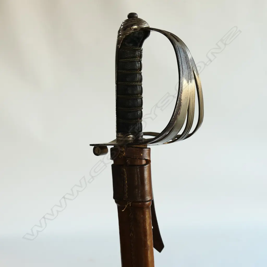 An 1845 pattern Officer's sword. As issued with very good brown leather scabbard. Nickel-plated hilt with open swept guard bugle cypher, Image 1++