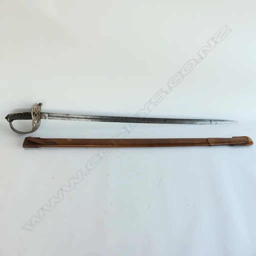 An 1845 pattern Officer's sword. As issued with very good brown leather scabbard. Nickel-plated hilt with open swept guard bugle cypher, Image 1++