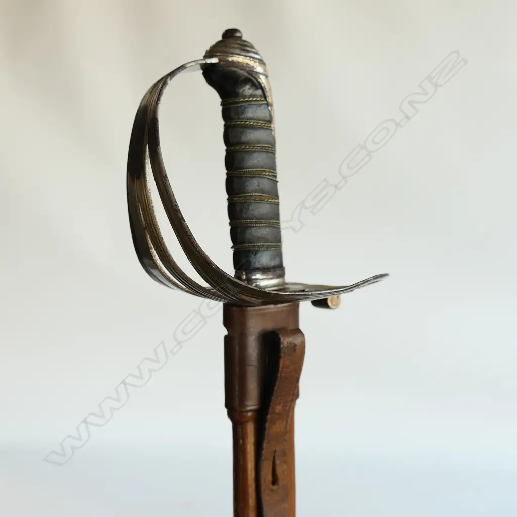 An 1845 pattern Officer's sword. As issued with very good brown leather scabbard. Nickel-plated hilt with open swept guard bugle cypher, Image 1++