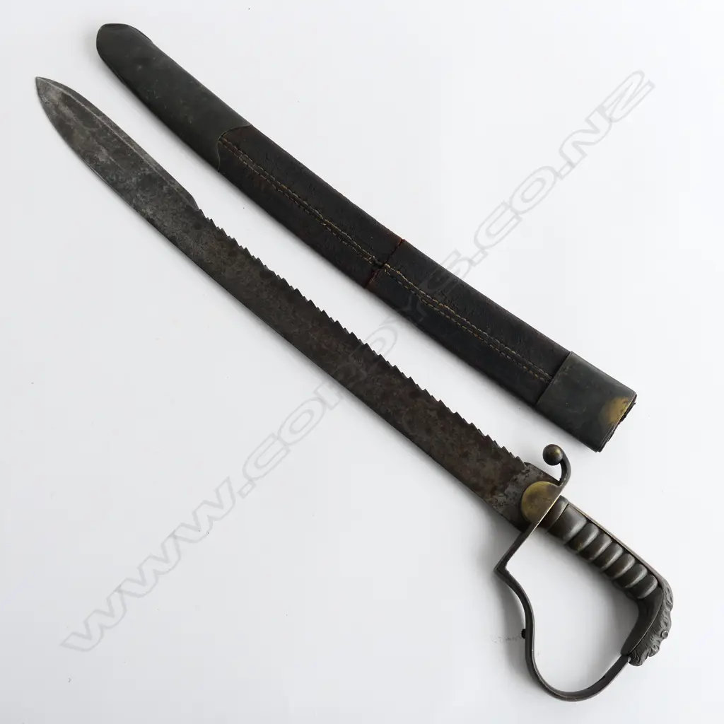 A c.1830 Pioneer Rifleman's sawback hanger, with spear point 600mm blade, brass P-guard hilt with lion's head pommel. Leather scabbard (nearly cracked through) with brass fittings Image 1++