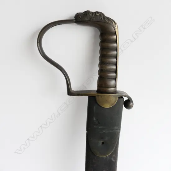 A c.1830 Pioneer Rifleman's sawback hanger, with spear point 600mm blade, brass P-guard hilt with lion's head pommel. Leather scabbard (nearly cracked through) with brass fittings