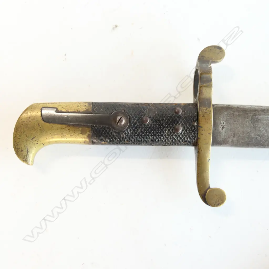 Lancaster Pattern 1855 bayonet with leather scabbard. Made for the Lancaster Carbine Rifle, pipe back spear pointed blade with even stained patina, leather grips and brass hilt, and crossguard numbered 108, brass mounted black leather scabbard with one crease. Image 1++