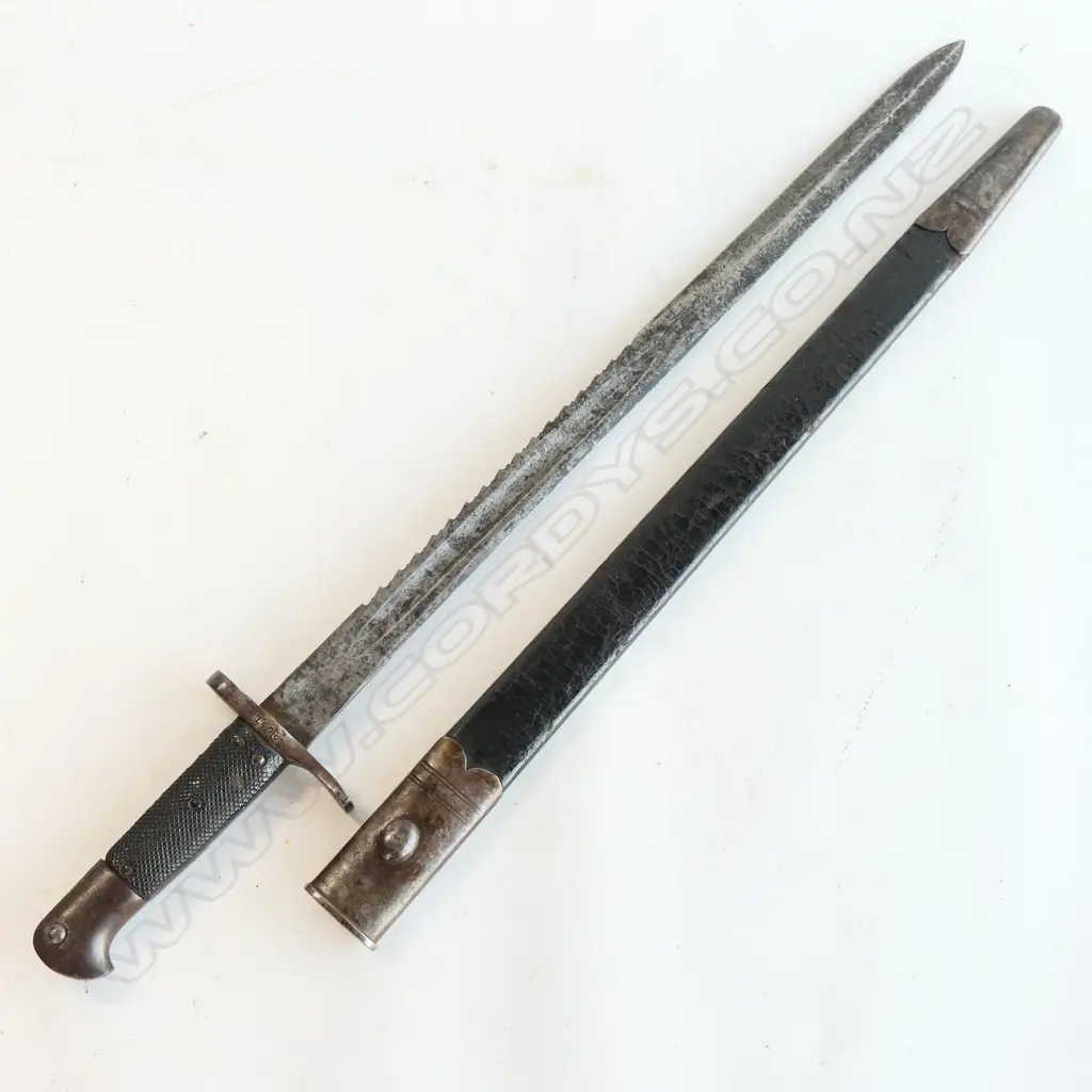 British Snider Sawback Bayonet and Leather Scabbard, 2nd type. Made for the NZ Artillery Carbine.  Blade L.515mm, with some staining and minor pitting, WD armoury marks and ‘9/81’ conversion mark at ricasso, numbered ‘1978’ at crossguard. Image 1++