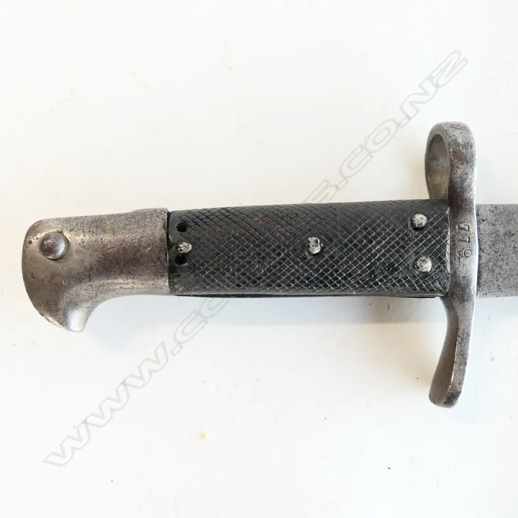 A Snider saw back sword bayonet, with leather grips. Pitted cross guard. Numbered 779. 510mm long saw back blade. Conversion date of 9 81. Some pitting at blade end. No scabbard. Image 1++