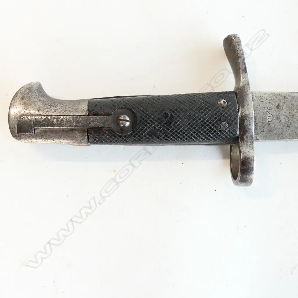 A Snider saw back sword bayonet, with leather grips. Pitted cross guard. Numbered 779. 510mm long saw back blade. Conversion date of 9 81. Some pitting at blade end. No scabbard. Image 1++