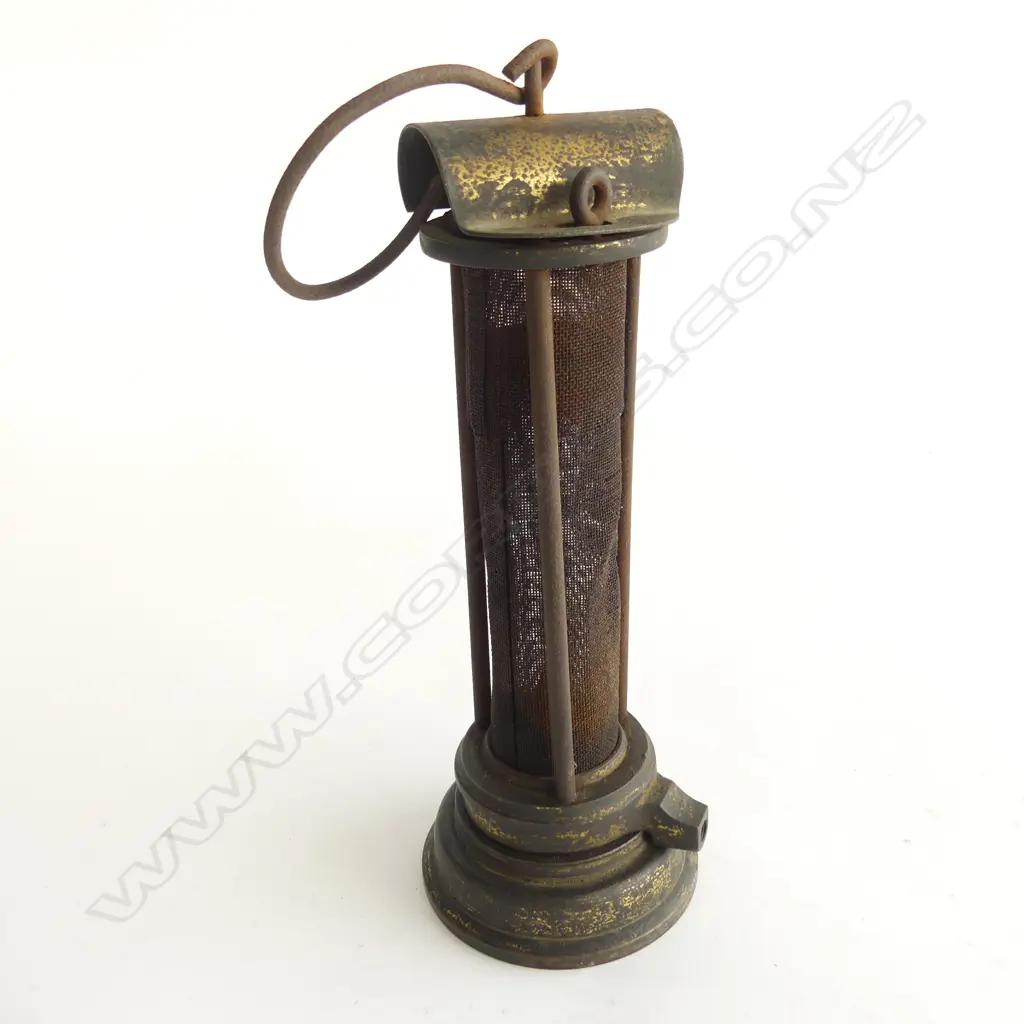 A miner's brass Safety Lamp, c.1900 Thomas & Williams style. The body being a long gauze section protected by three bars. H.235mm. Image 1++