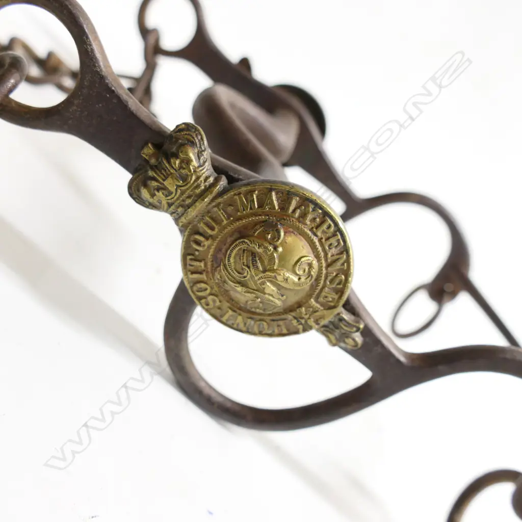 A Victorian military, steel horse bit with brass crowned garter bearing motto and cypher in bosses to either side. Image 1++