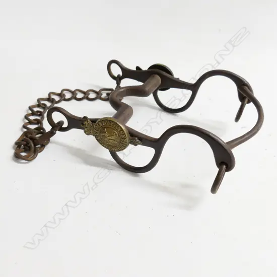 A Victorian military, steel horse bit with brass crowned garter bearing motto and cypher in bosses to either side.