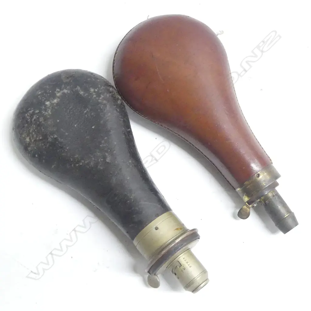 Two leather bag shaped powder flasks one black the other brown Image 1++