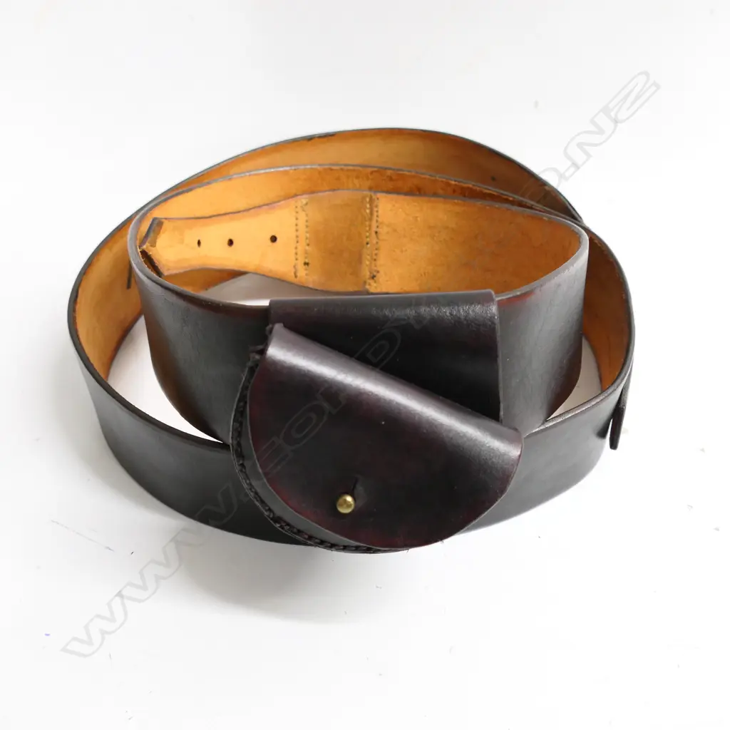 A reproduction 2¼" wide belt with pistol ammo pouch.  Inside of belt marked ‘WD 1859’ and ‘Moore Adams & Co C&M 1856 Christchurch’ Image 1++