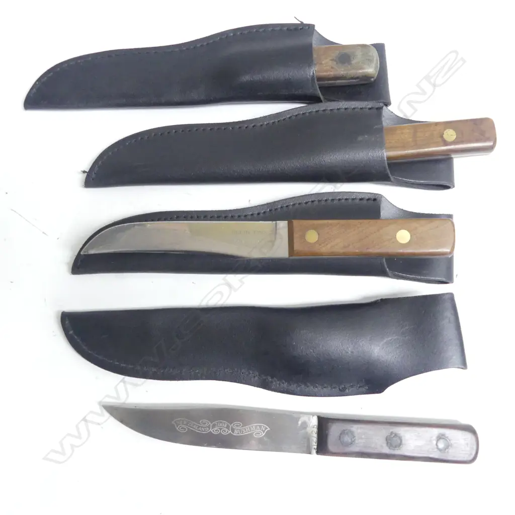 Four ‘New Zealand  Bushman’  knives with wooden grips and leather sheaths. Image 1++