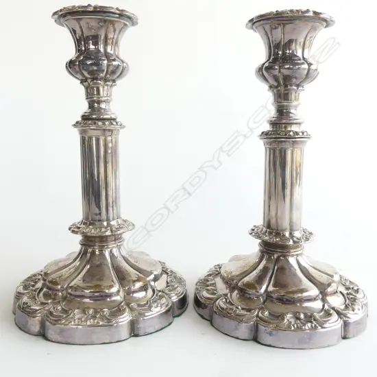 A pair of 19thC Old Sheffield Plate telescopic candlesticks. H.280mm extended. Note:  one telescopic extension faulted (does not remain extended and falls down). Dia. nozzle, 25mm and drip tray 63mm.