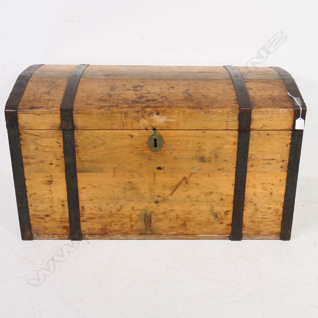 A Victorian pine, steel strapped and bound travelling trunk,  the mildly domed top with original pinned steel edging and strapping, swing handle to each side. 900 x 450 x 500mm. Image 1++
