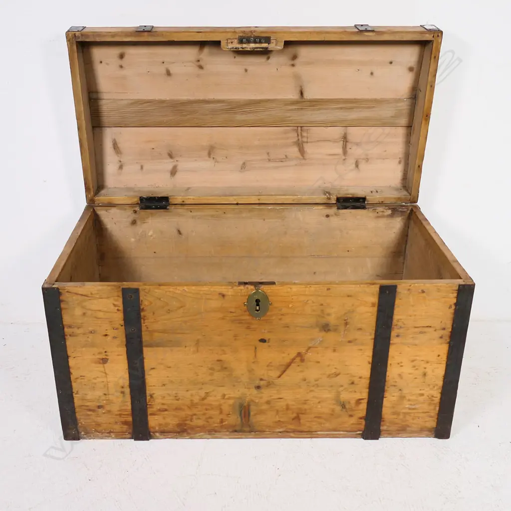 A Victorian pine, steel strapped and bound travelling trunk,  the mildly domed top with original pinned steel edging and strapping, swing handle to each side. 900 x 450 x 500mm. Image 1++