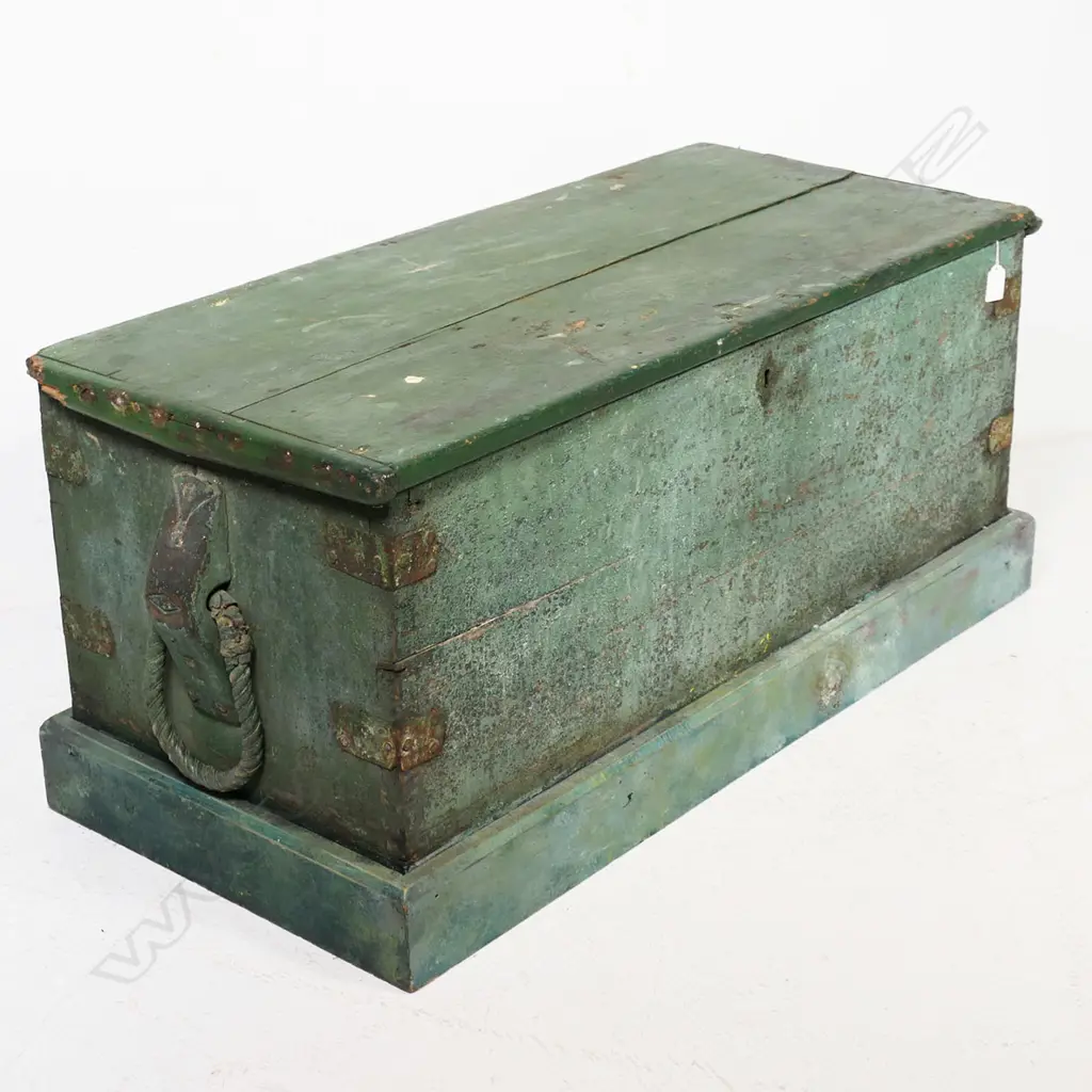 A 19thC green painted footlocker, with rope carry handles and iron strapped dovetailed corners, plinth base, hinged lid, candle box to interior, mortice lock with tongue absent. 950 x 420 x 430mm Image 1++