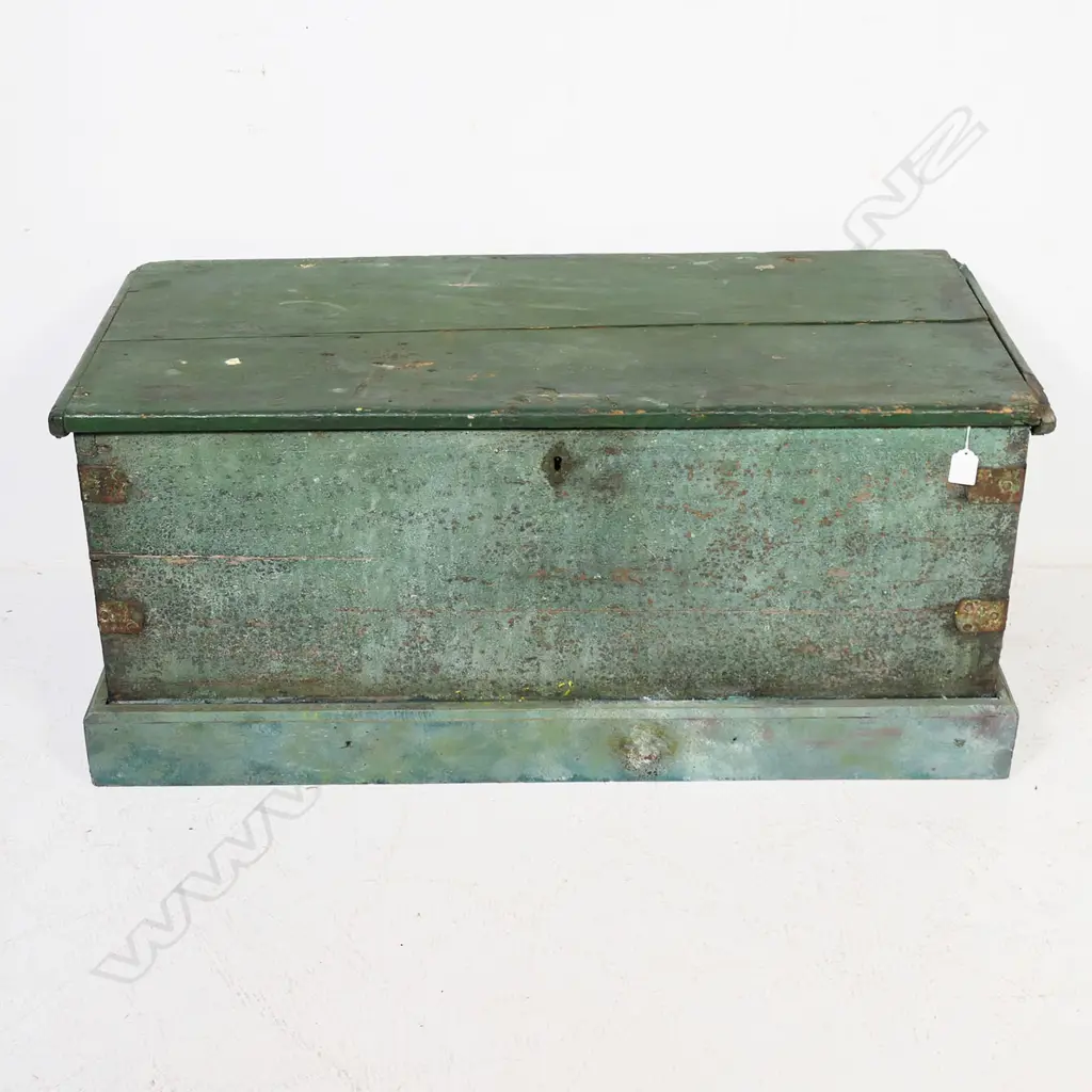 A 19thC green painted footlocker, with rope carry handles and iron strapped dovetailed corners, plinth base, hinged lid, candle box to interior, mortice lock with tongue absent. 950 x 420 x 430mm Image 1++