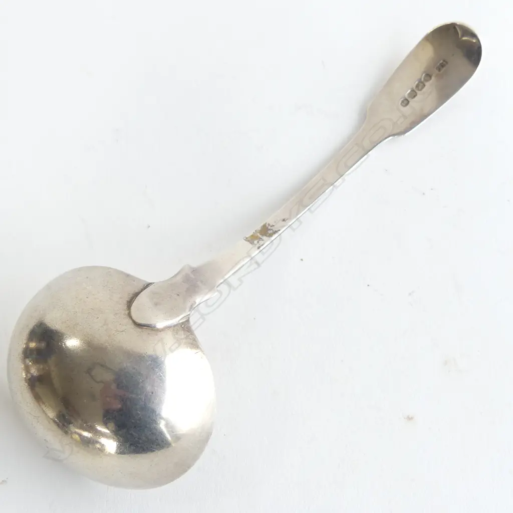 A silver sauce ladle fiddle pattern monogram on handle London 1822. 55gms.  Maker's initials T.B. L.180mm. Image 1++