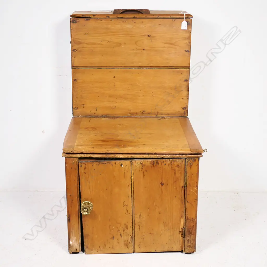 An earth closet commode of pine construction with ceramic rimmed opening bearing a printed logo for 'Moule's Patent Earth System, London'. Image 1++