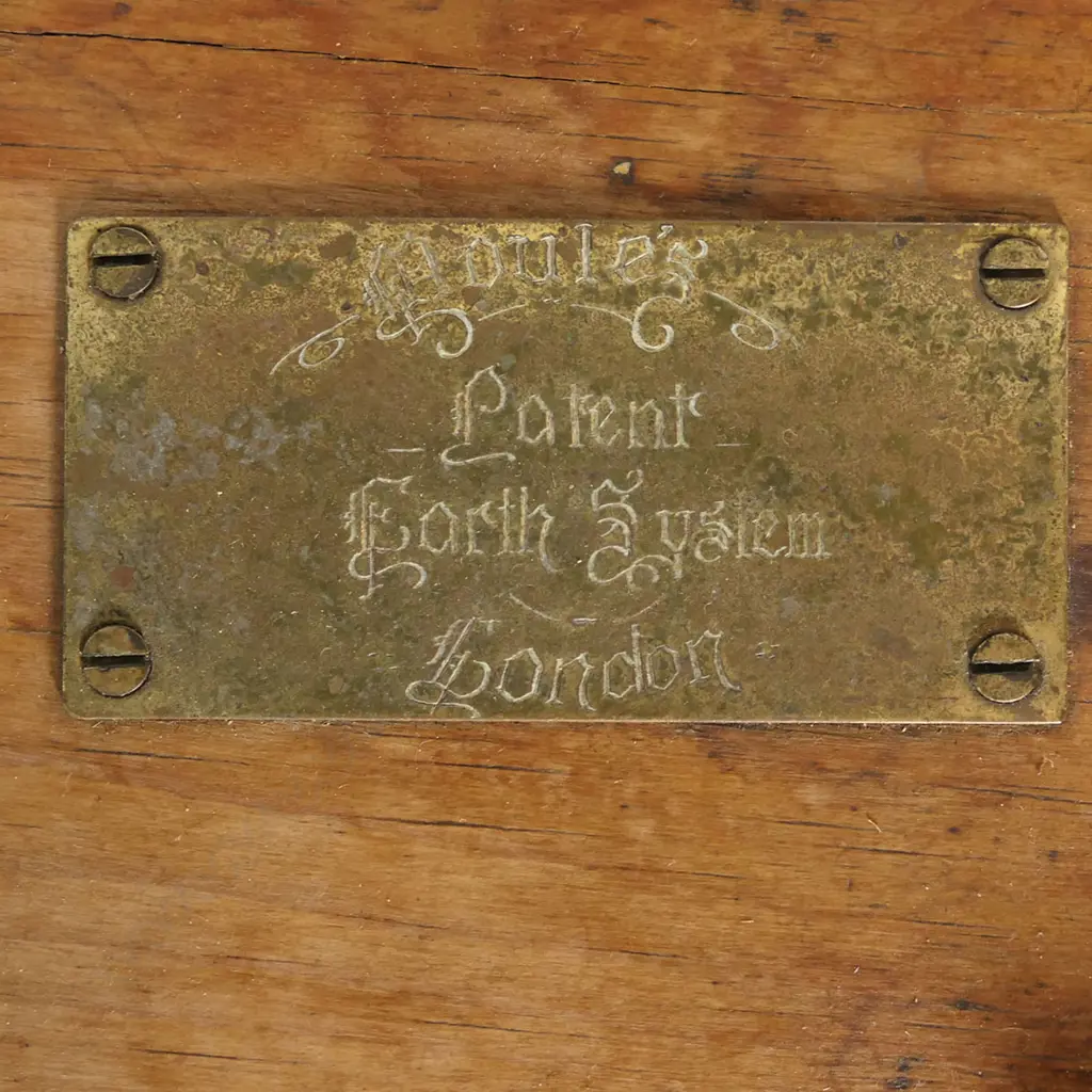 An earth closet commode of pine construction with ceramic rimmed opening bearing a printed logo for 'Moule's Patent Earth System, London'. Image 1++