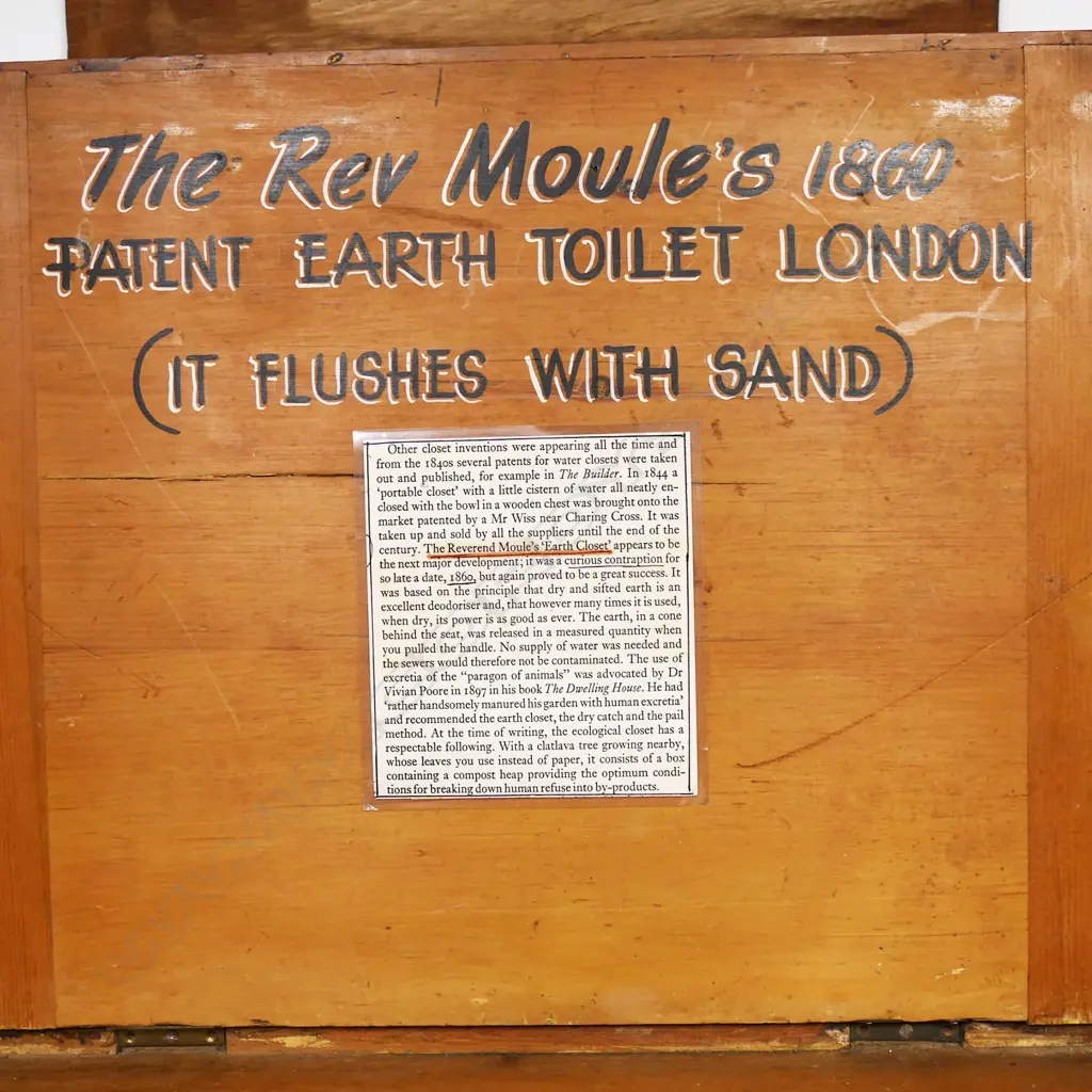 An earth closet commode of pine construction with ceramic rimmed opening bearing a printed logo for 'Moule's Patent Earth System, London'. Image 1++