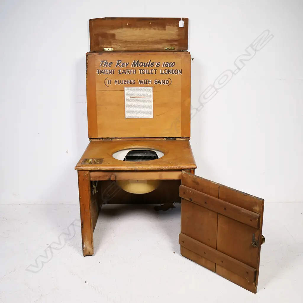 An earth closet commode of pine construction with ceramic rimmed opening bearing a printed logo for 'Moule's Patent Earth System, London'. Image 1++