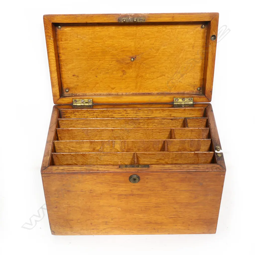 An oak stationary box with secured concealed drawer to the right hand side. Inlaid plaque absent from hinged lid. 310 x 230 x 170mm Image 1++