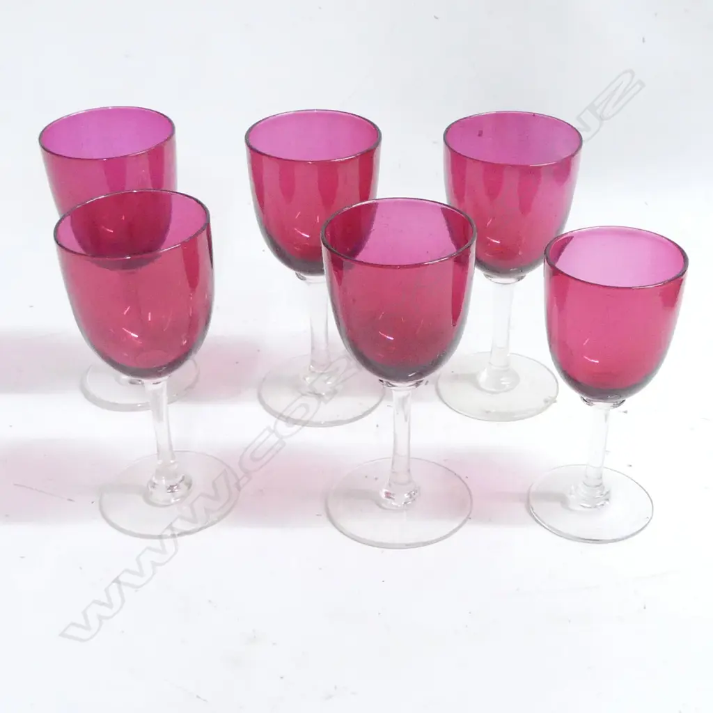 Six Victorian cranberry glass goblets with clear stems and circular feet. Approx. H.130mm. One slightly smaller. Image 1++
