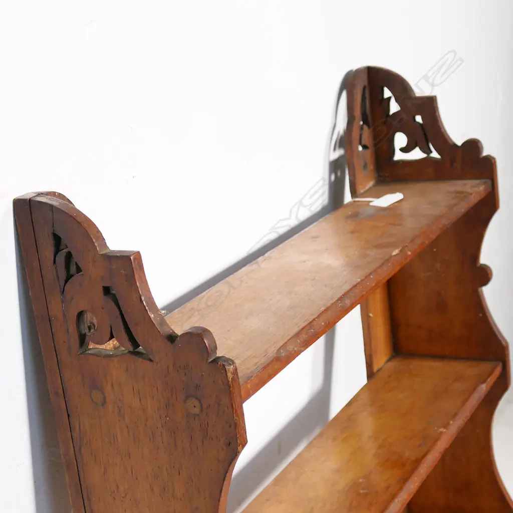 A late Victorian wall mounting oak book shelf of four shelves, with shaped supports and cut out top sections. H.970mm. Image 1++