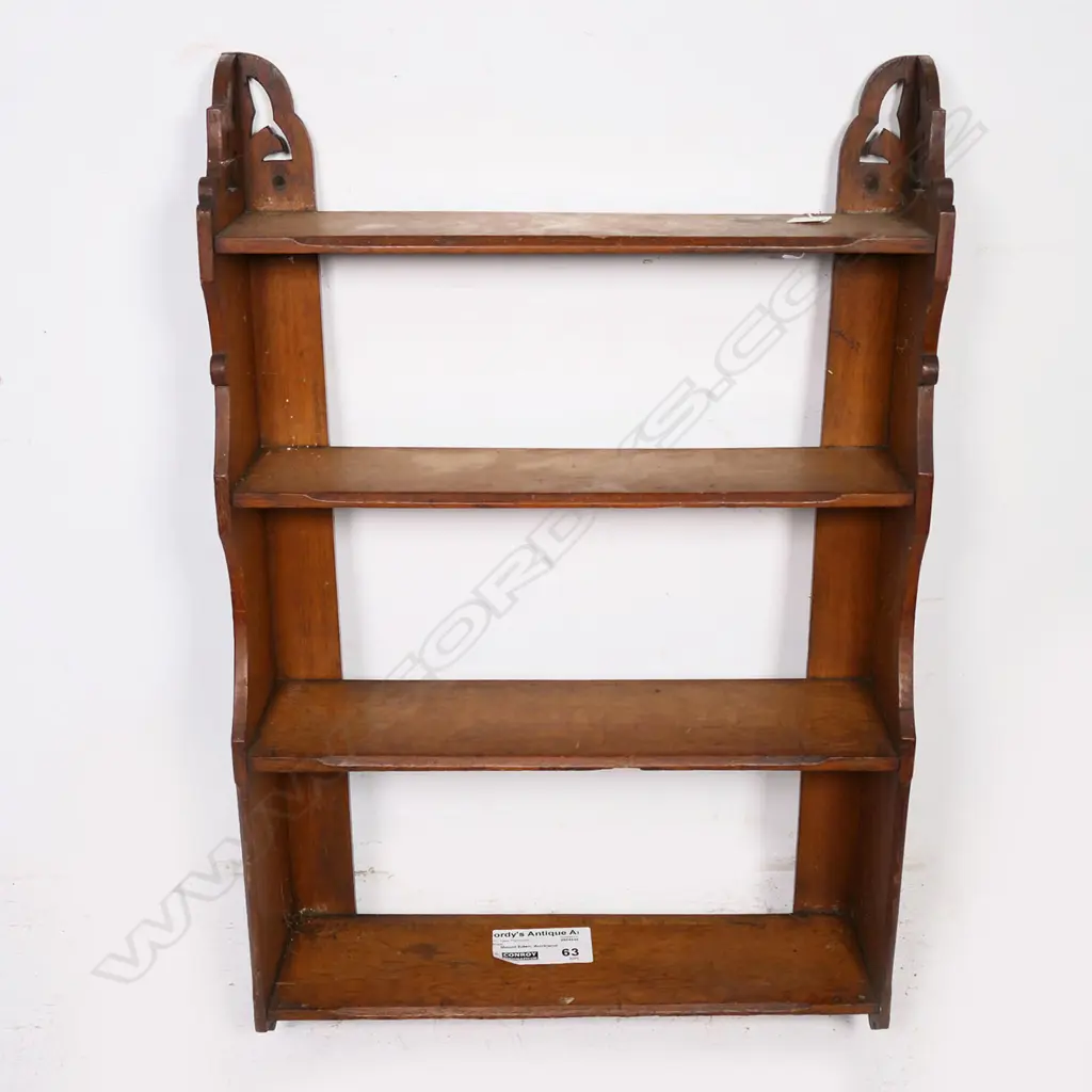 A late Victorian wall mounting oak book shelf of four shelves, with shaped supports and cut out top sections. H.970mm. Image 1++