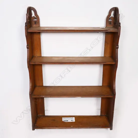 A late Victorian wall mounting oak book shelf of four shelves, with shaped supports and cut out top sections. H.970mm.
