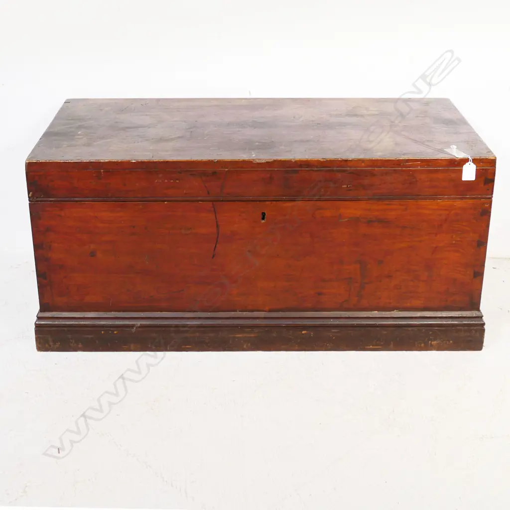 A New Zealand colonial dark stained kauri storage box of plain oblong shape with iron side handles, hinged lid. 910 x 450 x 425mm. Image 1++