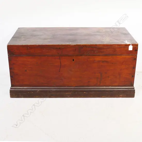 A New Zealand colonial dark stained kauri storage box of plain oblong shape with iron side handles, hinged lid. 910 x 450 x 425mm.