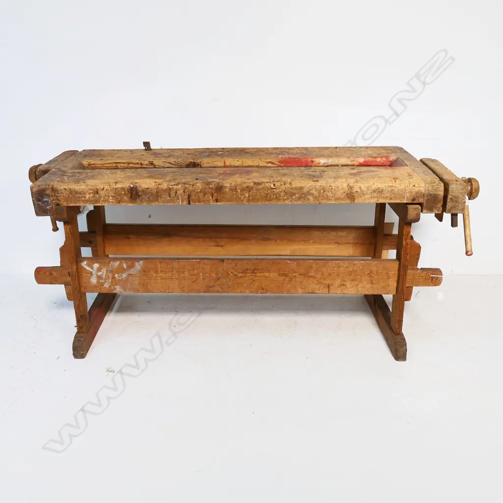 A Pine Carpenter's Bench, with vices to either end, raised on base with pegged morticed stretchers Image 1++