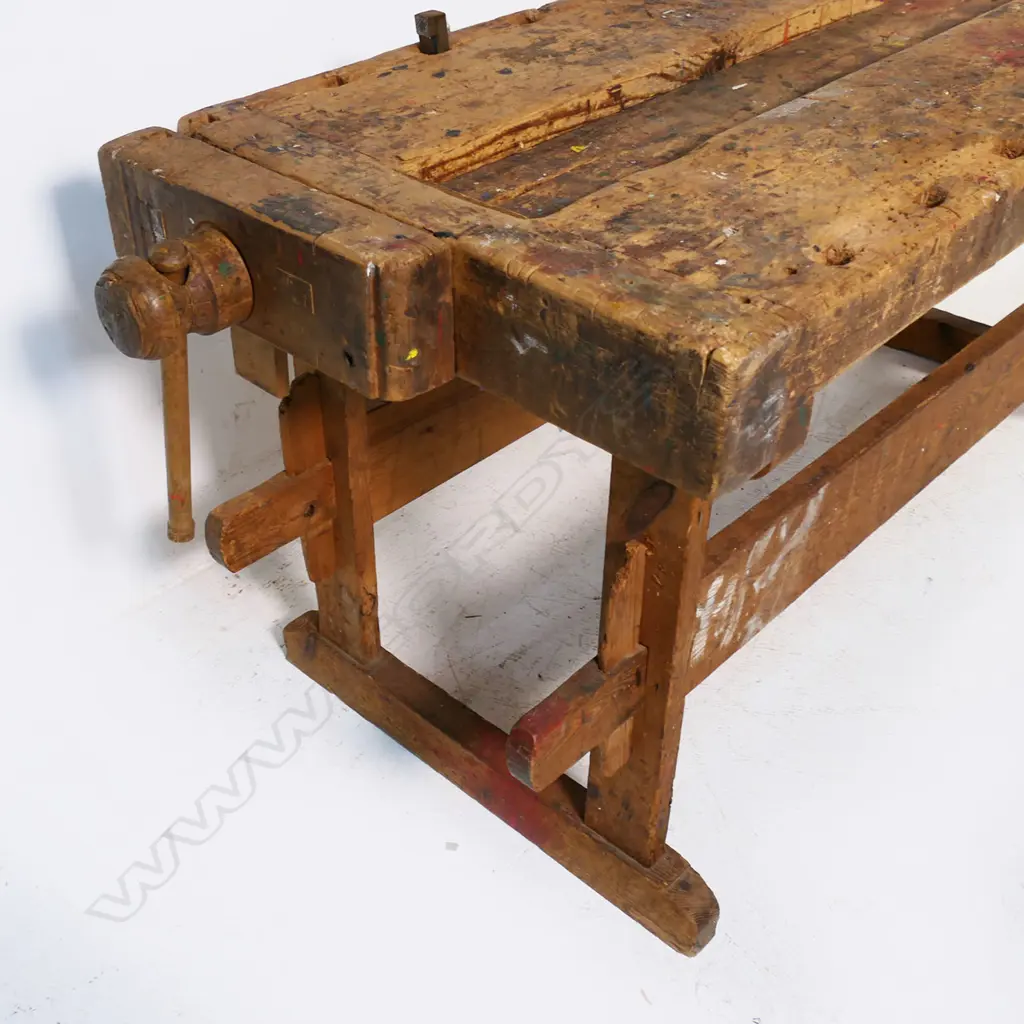A Pine Carpenter's Bench, with vices to either end, raised on base with pegged morticed stretchers Image 1++