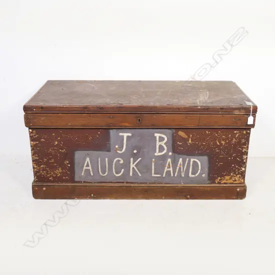 A colonial kauri carpenter's chest, dovetailed construction to the sides, plank top, steel carrying handles to the side and with fitted interior. 1040 x 490 x 510mm.