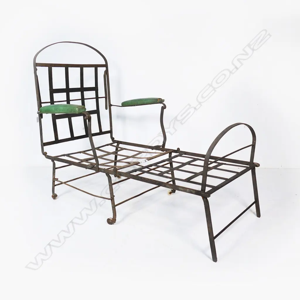 A wrought iron folding chair, on porcelain castors and later green padded arm rests Image 1++