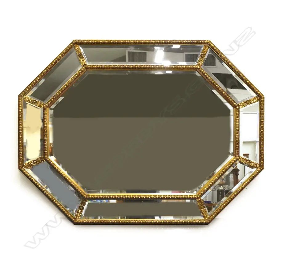 A decorative gilt framed wall mirror of octagonal shape Image 1++